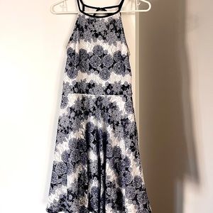 White and navy lace mini dress with high neck and keyhole back.